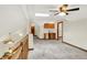 Carpeted loft area featuring skylight, wet bar, and multiple access doors at 37 Trotters Run, Brownsburg, IN 46112