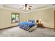This main bedroom has a tray ceiling, ceiling fan, and large window at 37 Trotters Run, Brownsburg, IN 46112