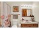 Powder room boasts marble countertop, wood vanity, and framed mirror at 37 Trotters Run, Brownsburg, IN 46112