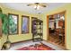 Bright sun room features three windows, decorative shelving, and tile floor at 37 Trotters Run, Brownsburg, IN 46112