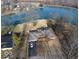 Aerial shot of brick home, long driveway and lake, with a car in the driveway at 3752 W North Wood Lake Dr, Columbus, IN 47201