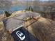 Aerial view of brick home with attached garage, long driveway, and lake in the background at 3752 W North Wood Lake Dr, Columbus, IN 47201