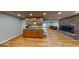 Open basement with a wet bar, brick fireplace and hardwood floors at 3752 W North Wood Lake Dr, Columbus, IN 47201