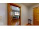 Hallway with hardwood floors, white walls, and doors leading to different rooms at 3752 W North Wood Lake Dr, Columbus, IN 47201