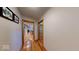 Hallway with hardwood floors, doorways leading to various rooms, and artwork on the walls at 3752 W North Wood Lake Dr, Columbus, IN 47201
