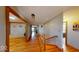 Well-lit hallway with hardwood floors and wooden trim, leading to various rooms at 3752 W North Wood Lake Dr, Columbus, IN 47201