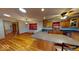 Open kitchen with modern countertops, wood cabinets, island with seating, and hardwood floors at 3752 W North Wood Lake Dr, Columbus, IN 47201