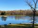 Scenic view of a lake on a sunny day, surrounded by trees and greenery at 3752 W North Wood Lake Dr, Columbus, IN 47201