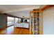 Open living room featuring a brick fireplace, hardwood floors, and sliding glass doors to a deck at 3752 W North Wood Lake Dr, Columbus, IN 47201