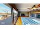 Open living room featuring a brick fireplace, hardwood floors, and sliding glass doors to the deck at 3752 W North Wood Lake Dr, Columbus, IN 47201
