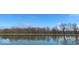 Scenic view of a tranquil pond reflecting the clear blue sky and surrounding trees at 3752 W North Wood Lake Dr, Columbus, IN 47201