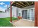 Cozy covered back patio with sliding door access and adjacent grassy area, perfect for outdoor relaxation at 451 Filmore Dr, Westfield, IN 46074