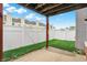Inviting back patio with a well-maintained grassy area and white fence, ideal for enjoying outdoor activities at 451 Filmore Dr, Westfield, IN 46074
