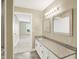 Bathroom with granite vanity, bright lighting, and access to the bedroom at 451 Filmore Dr, Westfield, IN 46074