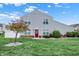 Well-maintained two-story home featuring a red front door, landscaped yard, and lovely curb appeal at 451 Filmore Dr, Westfield, IN 46074