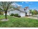 Well-maintained townhouse with attached garage and a lush green lawn at 451 Filmore Dr, Westfield, IN 46074