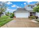 Front view of home featuring a large garage, well-kept lawn, and attractive landscaping at 451 Filmore Dr, Westfield, IN 46074