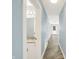 Light-filled hallway with gray plank flooring offering easy access to bathroom and living areas at 451 Filmore Dr, Westfield, IN 46074