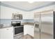 Corner kitchen featuring stainless steel appliances and white cabinets at 451 Filmore Dr, Westfield, IN 46074