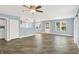 Spacious living room with new gray plank floors, ceiling fan, and plenty of natural light at 451 Filmore Dr, Westfield, IN 46074