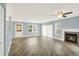 Inviting living room featuring gray plank flooring and a tiled fireplace for added warmth at 451 Filmore Dr, Westfield, IN 46074