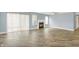 Bright living room featuring gray plank floors, sliding doors, and a cozy tile fireplace at 451 Filmore Dr, Westfield, IN 46074