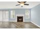 Cozy living room with tiled fireplace, gray plank flooring, and recessed lighting at 451 Filmore Dr, Westfield, IN 46074