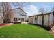 Large backyard with green grass, a patio area, a detached garage, and string lights at 5032 N Illinois St, Indianapolis, IN 46208
