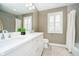 Bright bathroom with double vanity sink, white cabinets, and a large mirror at 5032 N Illinois St, Indianapolis, IN 46208