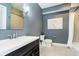Bathroom with a large sink, dark vanity, and a combination shower and tub at 5032 N Illinois St, Indianapolis, IN 46208