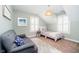 Bright bedroom features a single bed with a woven pendant lamp and a comfortable gray sofa at 5032 N Illinois St, Indianapolis, IN 46208