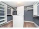 Walk-in closet features custom shelving and a storage island at 5032 N Illinois St, Indianapolis, IN 46208