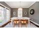 Charming dining room features a white table, natural wood chairs, and elegant decor for cozy gatherings at 5032 N Illinois St, Indianapolis, IN 46208