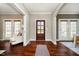 Elegant foyer boasting hardwood floors, a stylish rug, and a view into bright, inviting living spaces at 5032 N Illinois St, Indianapolis, IN 46208