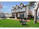 Inviting two-story home featuring a lush green lawn and Adirondack chairs for enjoying the outdoors at 5032 N Illinois St, Indianapolis, IN 46208