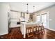 Bright kitchen featuring white cabinets, stainless steel appliances, and a large island with seating for casual dining at 5032 N Illinois St, Indianapolis, IN 46208