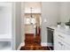 The kitchen flows to an open floor plan with stainless steel appliances and granite countertops at 5032 N Illinois St, Indianapolis, IN 46208