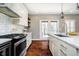 Beautiful kitchen features stainless steel appliances, stone countertops, and hardwood flooring at 5032 N Illinois St, Indianapolis, IN 46208