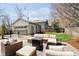 Outdoor patio featuring comfortable seating, a fire pit, and access to a detached garage at 5032 N Illinois St, Indianapolis, IN 46208