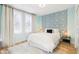 Light and airy bedroom with patterned accent wall and white bedding at 546 E Merrill St, Indianapolis, IN 46203