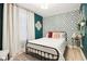 Bedroom featuring patterned accent wall, stylish decor and natural light at 546 E Merrill St, Indianapolis, IN 46203