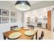 Open dining area with wood table, modern lighting and view to the kitchen at 546 E Merrill St, Indianapolis, IN 46203