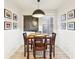 Bright dining room featuring modern chandelier, wood floors, and a wood dining set at 546 E Merrill St, Indianapolis, IN 46203