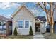 Charming home featuring mature trees, neutral siding, updated windows and front entrance with walkway at 546 E Merrill St, Indianapolis, IN 46203