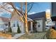 Charming home featuring mature trees, neutral siding, updated windows and front entrance with walkway at 546 E Merrill St, Indianapolis, IN 46203