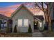 Charming home featuring mature trees, neutral siding, updated windows and front entrance with walkway at 546 E Merrill St, Indianapolis, IN 46203