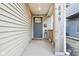 Inviting covered porch with front door, house numbers, and neutral siding at 546 E Merrill St, Indianapolis, IN 46203