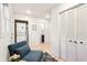 Cozy hallway features a stacked washer/dryer unit, comfortable seating and access to a bathroom at 546 E Merrill St, Indianapolis, IN 46203
