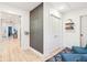 Bright hallway features wood floors, chalkboard wall art, closet, and open view to the main living area at 546 E Merrill St, Indianapolis, IN 46203