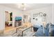 Bright living room with modern chandelier, wood floors, and a comfortable blue sectional sofa at 546 E Merrill St, Indianapolis, IN 46203